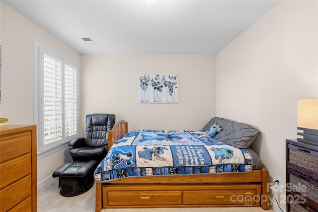 bedroom featuring light carpet, baseboards, and visible vents