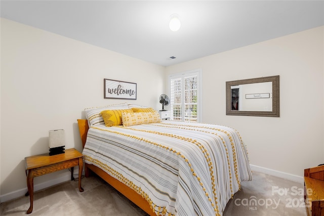 carpeted bedroom featuring baseboards