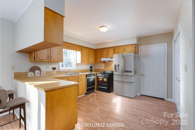 kitchen featuring a peninsula, stainless steel fridge with ice dispenser, black dishwasher, gas range oven, and exhaust hood