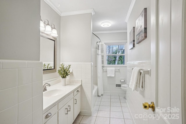 full bathroom with toilet, vanity, tile walls, tile patterned floors, and crown molding