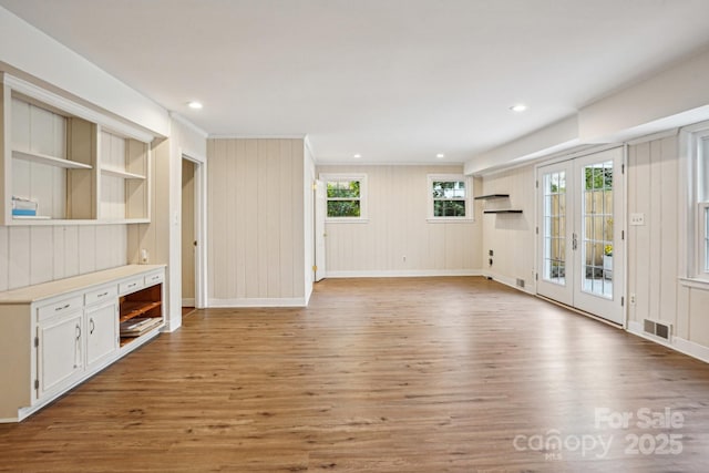 unfurnished living room featuring baseboards, visible vents, wood finished floors, french doors, and recessed lighting