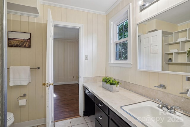 bathroom with toilet, tile patterned flooring, crown molding, and vanity