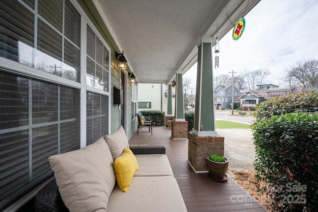 view of patio featuring a porch and a residential view