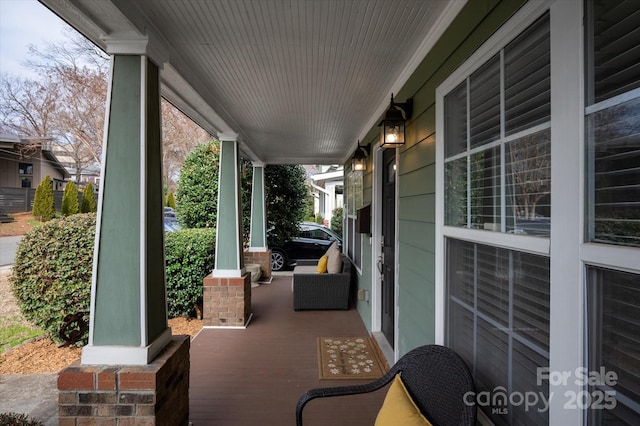 view of patio featuring a porch and a carport