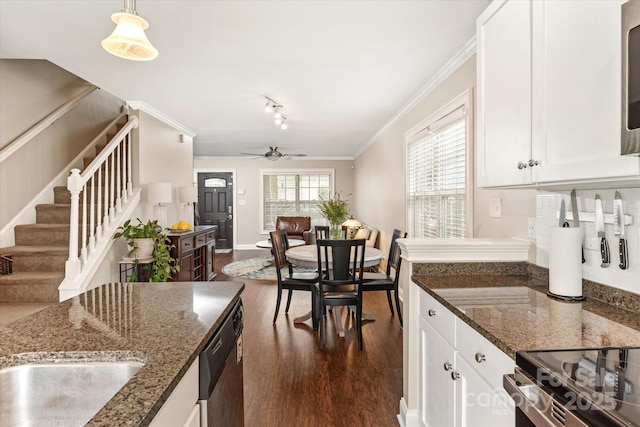 kitchen featuring dark stone counters, white cabinetry, and pendant lighting