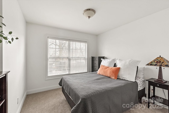 bedroom with baseboards and light colored carpet