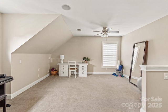 office area featuring baseboards, visible vents, a ceiling fan, light colored carpet, and lofted ceiling