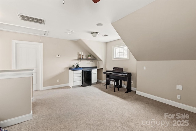 office space featuring baseboards, light colored carpet, visible vents, and attic access