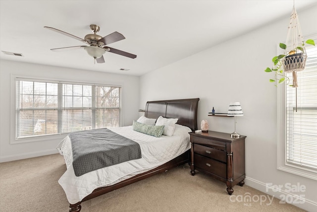 bedroom featuring baseboards, ceiling fan, visible vents, and light colored carpet