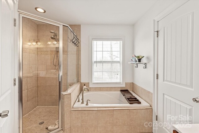 full bathroom featuring a stall shower and a bath