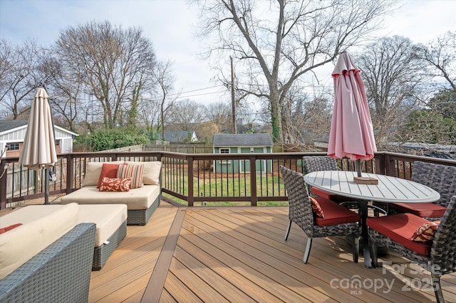 wooden deck featuring an outbuilding, outdoor dining area, a fenced backyard, an outdoor living space, and a shed