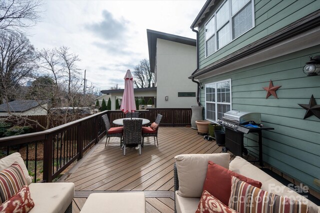 wooden deck with outdoor dining space, outdoor lounge area, and grilling area