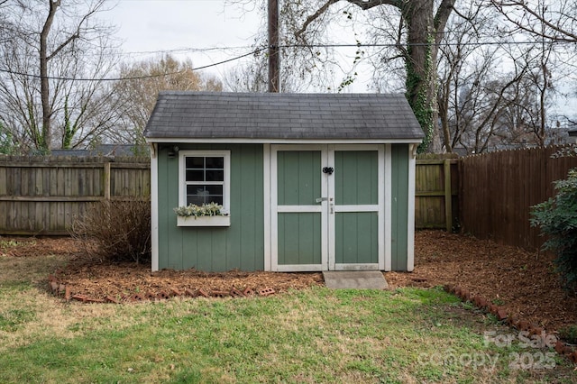 view of shed featuring a fenced backyard