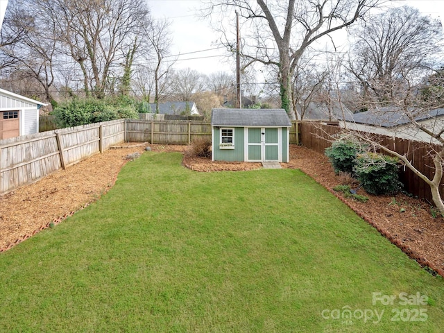 view of yard featuring a fenced backyard, a storage unit, and an outdoor structure