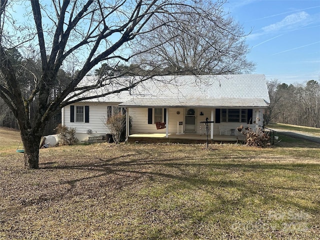 ranch-style home with covered porch and a front lawn