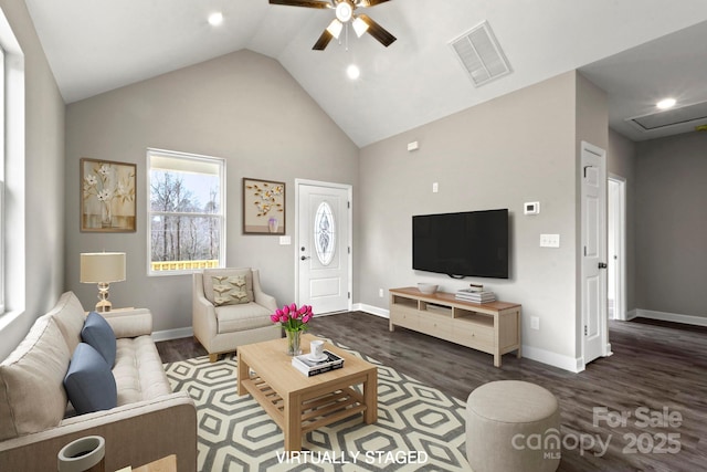 living room featuring dark wood-type flooring, high vaulted ceiling, and ceiling fan