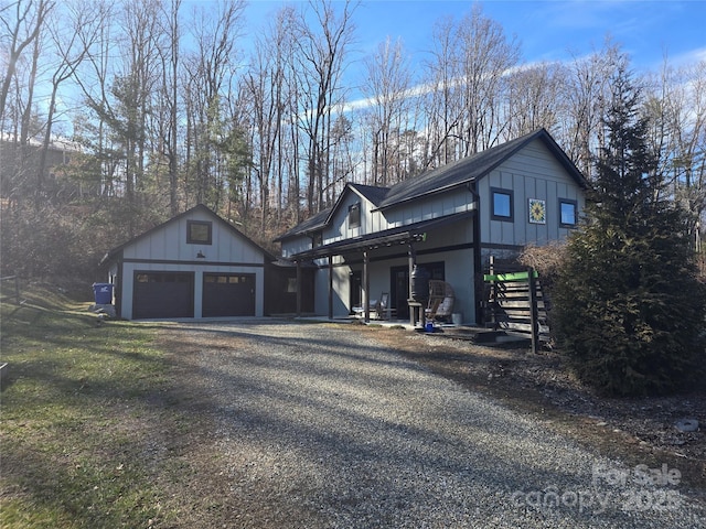 view of side of home featuring an outbuilding and a garage