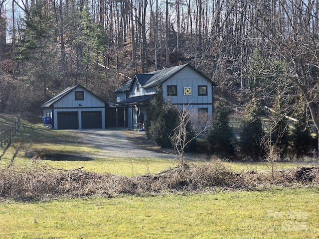 view of home's exterior with a garage, an outdoor structure, and a lawn