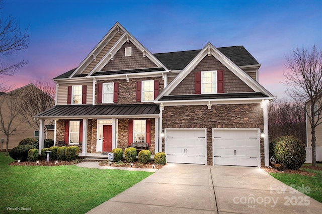 craftsman house featuring a porch, a garage, and a yard