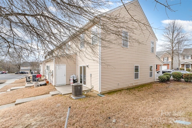 view of home's exterior featuring a residential view, a patio, and central AC unit