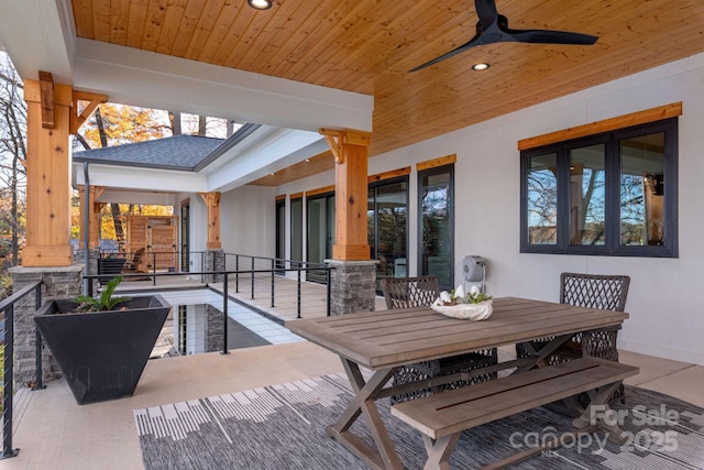 view of patio featuring outdoor dining area and ceiling fan