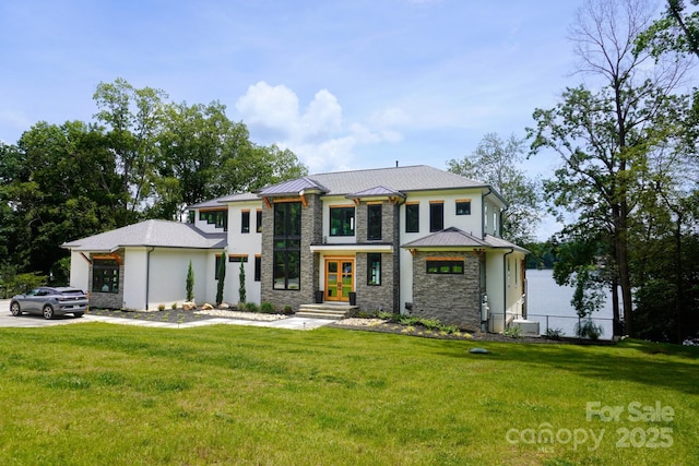 180 Willow Point Rd, Troutman, NC 28166 - contemporary home featuring french doors, stone siding, a front lawn, and a standing seam roof