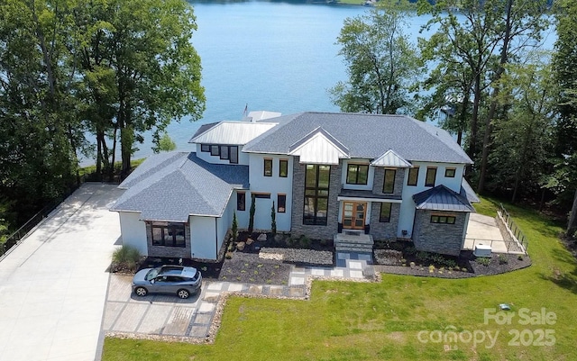 180 Willow Point Rd, Troutman, NC 28166 - view of front of home featuring stone siding, concrete driveway, a water view, and a front yard