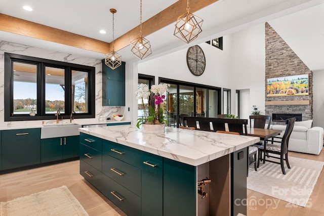 180 Willow Point Rd, Troutman, NC 28166 - kitchen featuring green cabinetry, a kitchen island, light wood finished floors, pendant lighting, and recessed lighting