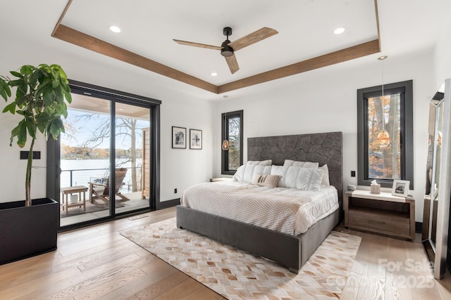 180 Willow Point Rd, Troutman, NC 28166 - bedroom with a tray ceiling, access to exterior, light wood finished floors, recessed lighting, and ceiling fan