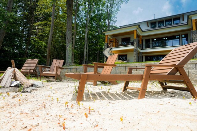 180 Willow Point Rd, Troutman, NC 28166 - exterior space with stairway, a balcony, and an outdoor fire pit