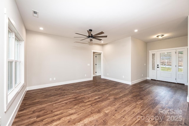 unfurnished room featuring dark wood-type flooring and ceiling fan