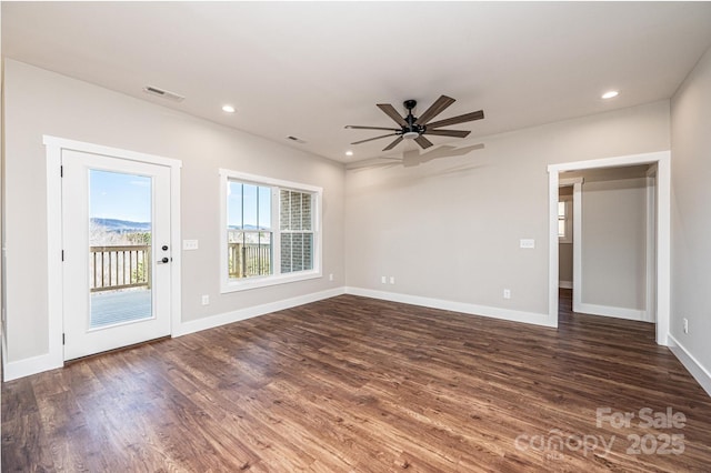 unfurnished living room featuring dark hardwood / wood-style floors and ceiling fan