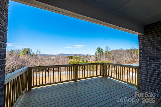 wooden terrace featuring a mountain view