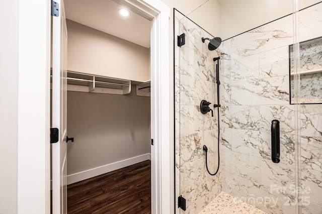 bathroom featuring hardwood / wood-style flooring and a shower with door