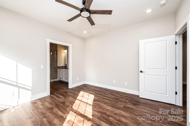 unfurnished bedroom featuring dark hardwood / wood-style floors, ceiling fan, and ensuite bathroom