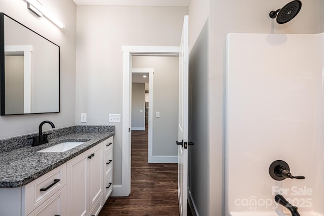 bathroom featuring vanity, wood-type flooring, and walk in shower