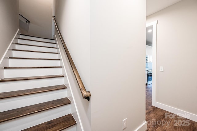 stairs featuring hardwood / wood-style floors