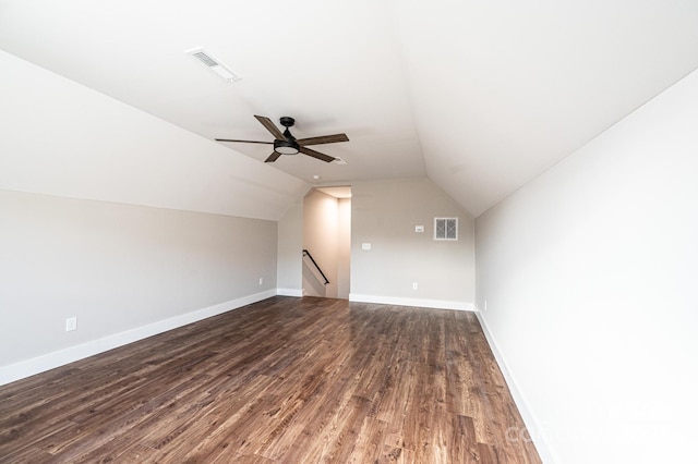 additional living space with ceiling fan, dark hardwood / wood-style floors, and vaulted ceiling