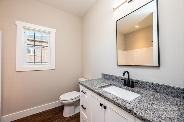 bathroom with vanity, hardwood / wood-style floors, and toilet