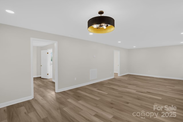 empty room with light hardwood / wood-style flooring