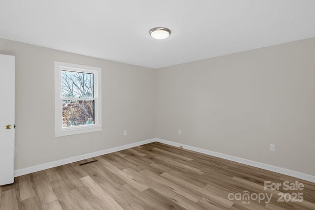 unfurnished room with light hardwood / wood-style flooring