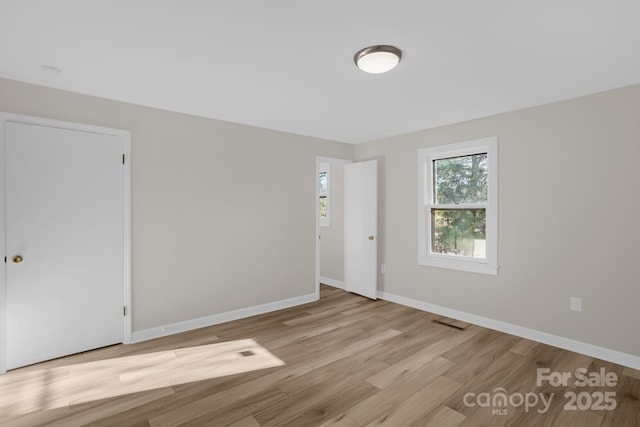 unfurnished room with light hardwood / wood-style flooring