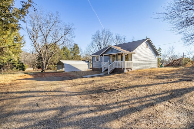 view of front of house featuring an outbuilding and covered porch