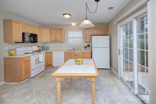 kitchen with light brown cabinetry, hanging light fixtures, white appliances, and sink