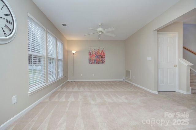 unfurnished room with ceiling fan and light colored carpet