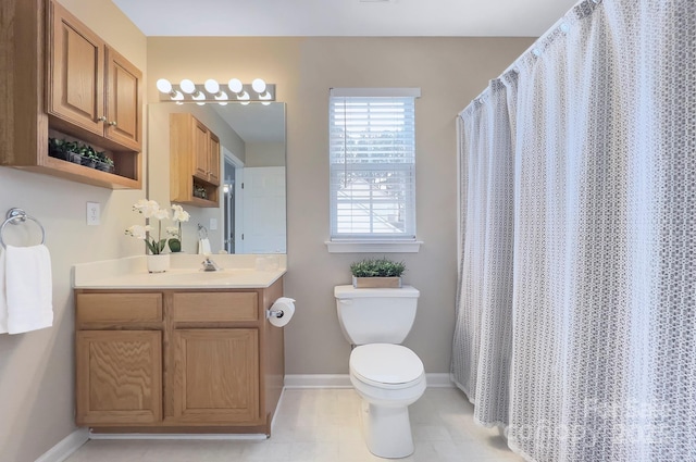 bathroom featuring vanity, walk in shower, and toilet