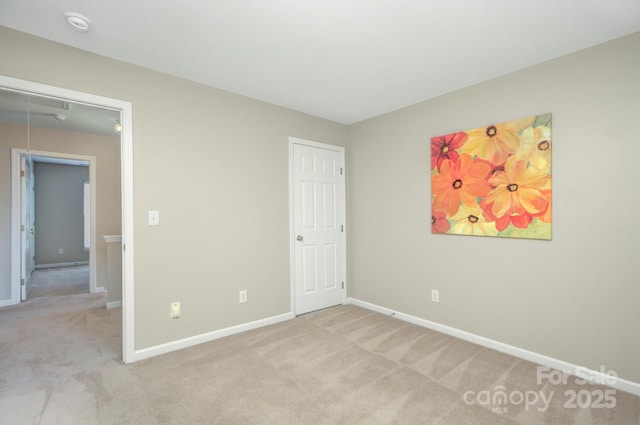 unfurnished bedroom featuring light carpet