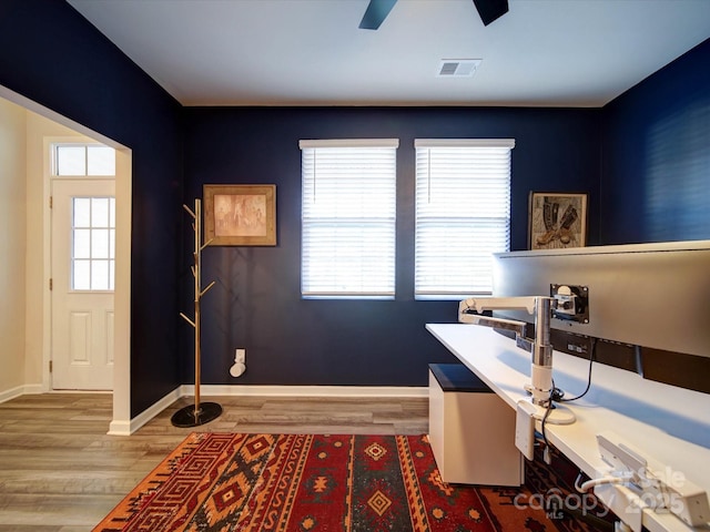 office with ceiling fan and light hardwood / wood-style flooring