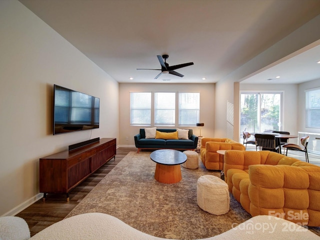 living room featuring dark hardwood / wood-style floors and ceiling fan