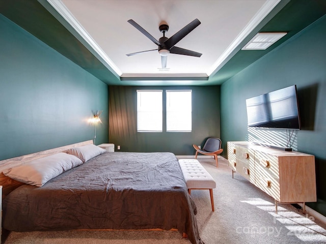 carpeted bedroom featuring ornamental molding, a raised ceiling, and ceiling fan